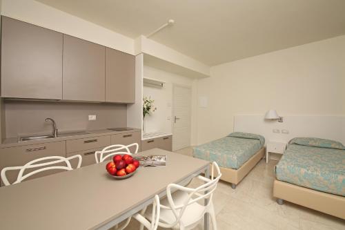 a kitchen and living room with a table and chairs at Hotel Holiday in Sirmione