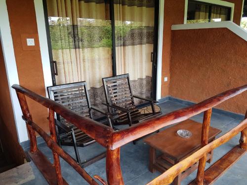 two chairs and a table on a porch at Sigiri Heritage Villa in Sigiriya
