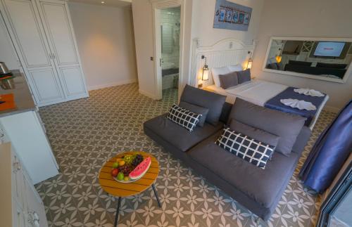 a living room with a couch and a bed at Marmaris Beach Hotel in Marmaris