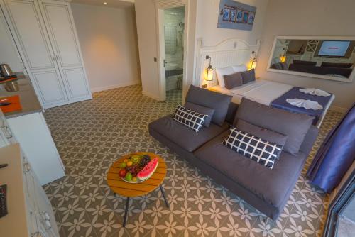 a living room with a couch and a bed at Marmaris Beach Hotel in Marmaris