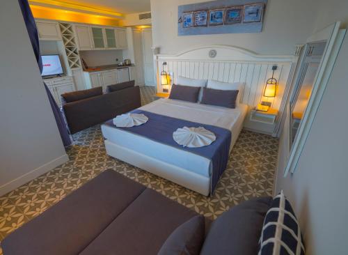 a hotel room with a bed and a couch at Marmaris Beach Hotel in Marmaris