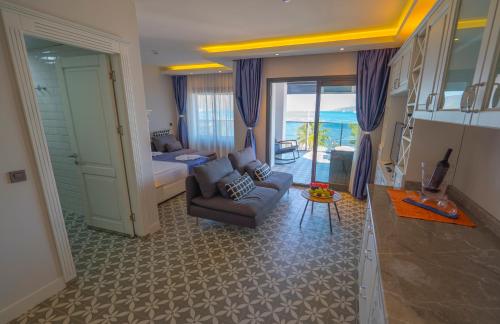 a living room with a bed and a couch at Marmaris Beach Hotel in Marmaris