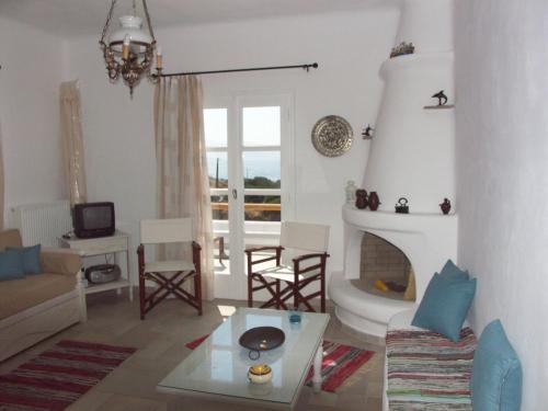 a living room with a couch and a fireplace at Karades Houses Medusa in Plaka