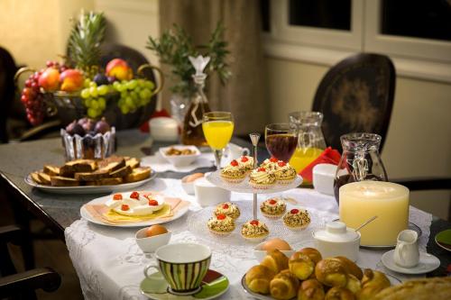 a table topped with food and drinks and a candle at Pansion Zafeiriou in Kastoria