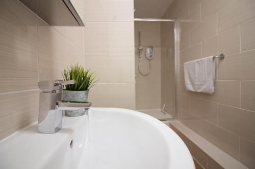 a bathroom with a white toilet and a shower at Castle Point Apartments Southampton Premier Lodge in Southampton
