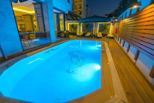 a swimming pool at night with blue lights at Marmaris Beach Hotel in Marmaris