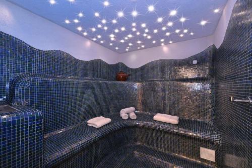 a bathroom with a tub with stars on the ceiling at Hotel Tyrol in Bressanone
