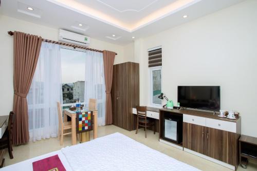 Télévision ou salle de divertissement dans l'établissement Friendly Home Hotel
