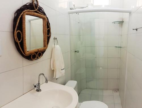 a bathroom with a sink and a shower at Pousada Beira Rio Parnaíba in Parnaíba