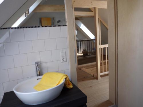 a bathroom with a white tub on a black counter at Fewo-Lenz in Hermagor