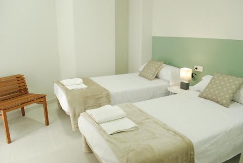 Un pat sau paturi într-o cameră la Puerta de Serranos