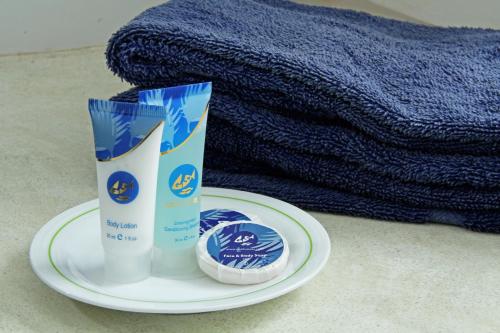 a plate with a container of sunscreen and a towel at Goldi Sands Hotel in Negombo