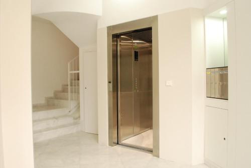 a hallway with a glass door leading to a staircase at Puerta de Serranos in Valencia