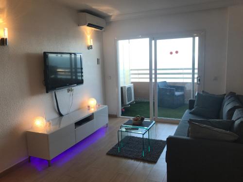 - un salon avec un canapé et une télévision dans l'établissement Apartment Stella Maris, à Fuengirola