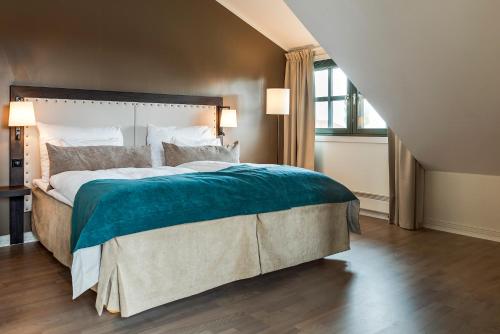 a bedroom with a large bed and a window at Clarion Hotel Oslo Airport in Gardermoen