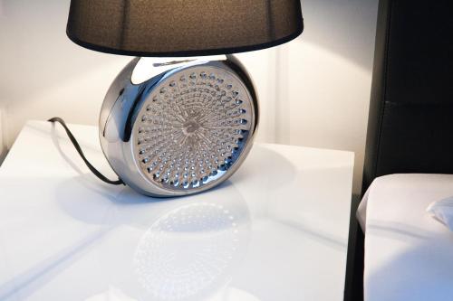 a lamp sitting on top of a white table at Hotel Stay in Essen