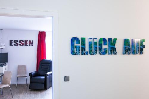 an open door into a room with a chair at art Hotel Körschen in Essen