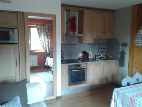 a kitchen with a sink and a stove at Gite Habsiger in Ottrott