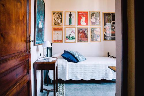 een slaapkamer met een bed en foto's aan de muur bij La Casetta Di Filippo E Chiara in Pisa