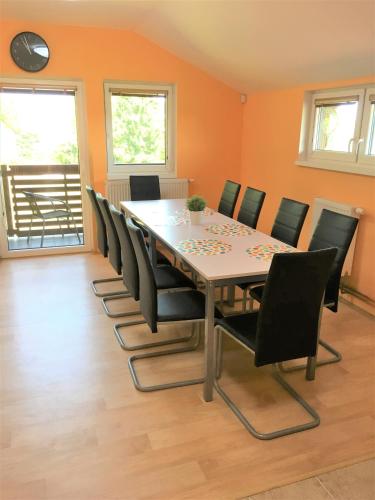 a dining room with a table and chairs at PENZION HNAČOV in Zavlekov