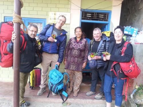 a group of people standing in front of a building at Bandipur Samira Homestay & Mountain View Restaurant in Bandīpur
