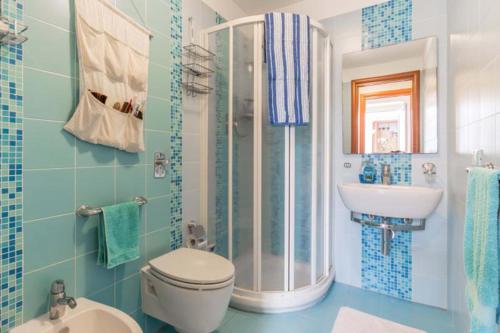 a bathroom with a shower and a toilet and a sink at La Casa di Romi in Marina di Ragusa