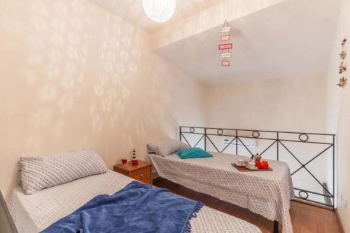a room with two beds in a room at La Casa di Romi in Marina di Ragusa