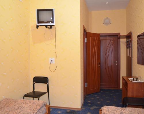 a room with a television and a bed in it at Sfinks in Zaporozhye