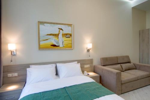 a hotel room with a bed and a couch at Summit Apart Hotel in Kyiv