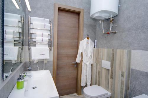 a bathroom with a toilet and a sink at Summit Apart Hotel in Kyiv