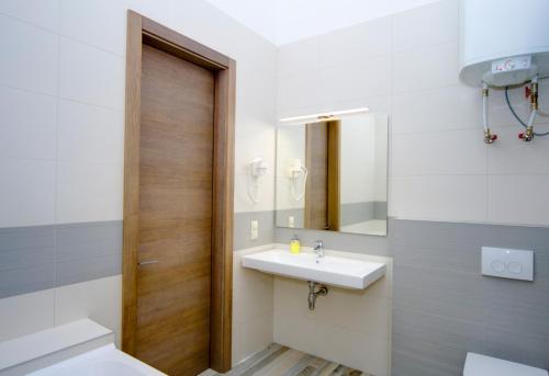 a bathroom with a sink and a mirror at Summit Apart Hotel in Kyiv