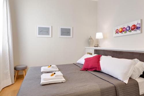 a bedroom with a bed with two towels on it at Rome as you feel - Grotta Pinta apartments in Rome