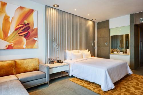 a hotel room with a bed and a couch at Avasa Hotel in Hyderabad