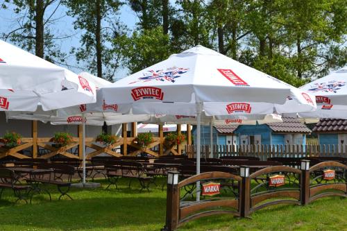 a group of white umbrellas sitting on a table at Camping Szczecinek Domy Wypoczynkowe in Szczecinek