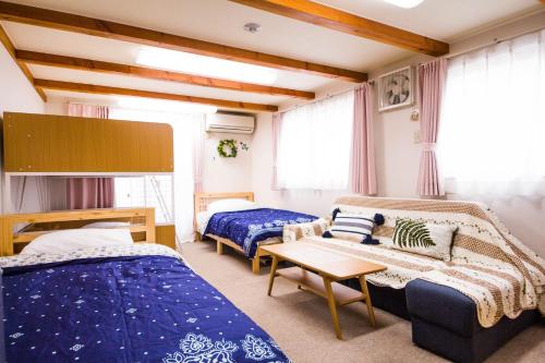 Postel nebo postele na pokoji v ubytování The Familiar Inn ー 旅館ホテル業