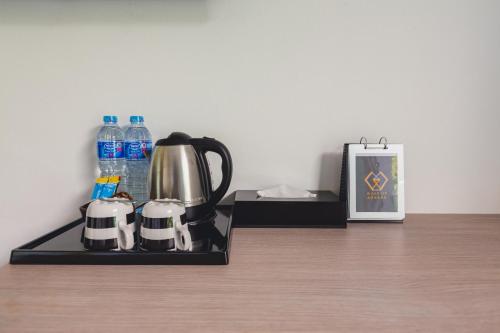 a coffee maker on a tray next to a bottle of water at Wake Up Aonang Hotel- SHA EXTRA PLUS in Ao Nang Beach