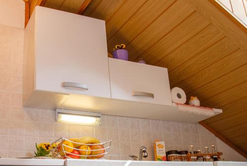a kitchen with a white cabinet above a sink at Apartment Ferk in Zagreb