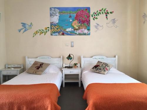 two beds sitting next to each other in a room at Harry's Studios 1 in Gaios