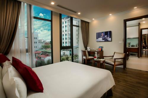 a hotel room with a bed and a large window at Au Coeur d'Hanoi Apartment in Hanoi