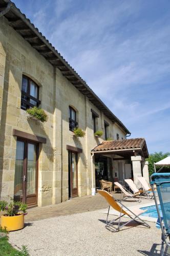 - deux chaises assises à l'extérieur d'un bâtiment dans l'établissement L'Etape, à Vayres