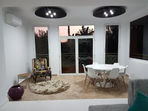 a living room with a table and chairs at Oxygène in Marrakech