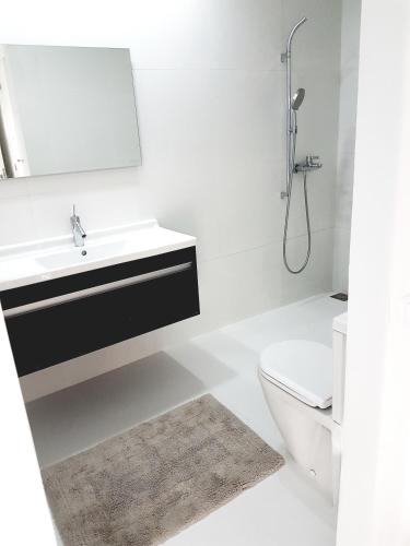 a bathroom with a sink and a toilet and a mirror at Oxygène in Marrakech