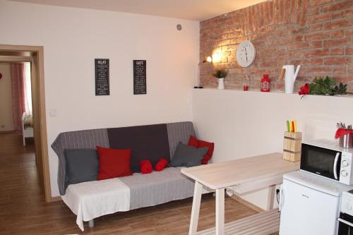 a living room with a couch and a table at Comfortable apartments under the St. Barbara´s Cathedral in Kutná Hora