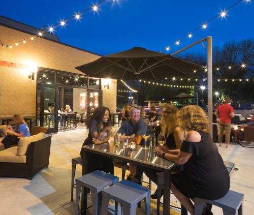 a group of people sitting at a table with wine glasses at Hotel Grinnell, Ascend Hotel Collection in Grinnell