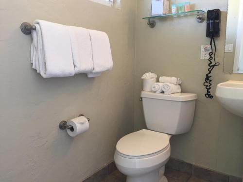
a white toilet sitting next to a white sink at Surfer Beach Hotel in San Diego
