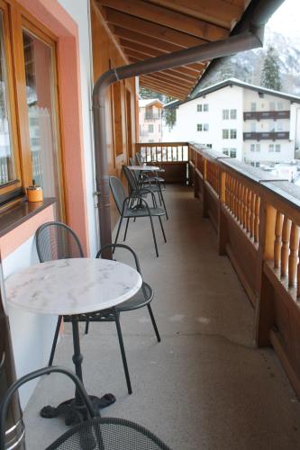 a row of tables and chairs on a balcony at Haus Regenbogen in Pertisau