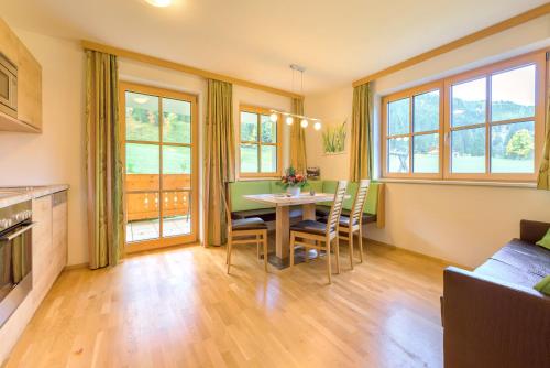 a kitchen and dining room with a table and chairs at ARCHE Hof Öbristhof in Kleinarl