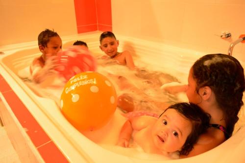 a group of children playing in a bath tub at Hotel Spa Casa de Adobe Villa de Leyva in Villa de Leyva