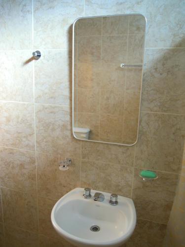 a bathroom with a sink and a mirror at Cabañas y Hotel Ebemys in San Agustín de Valle Fértil