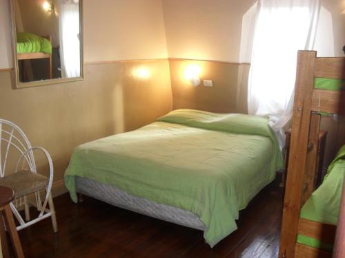 a small bedroom with a bed and a mirror at Hotel De La Rue in Buenos Aires